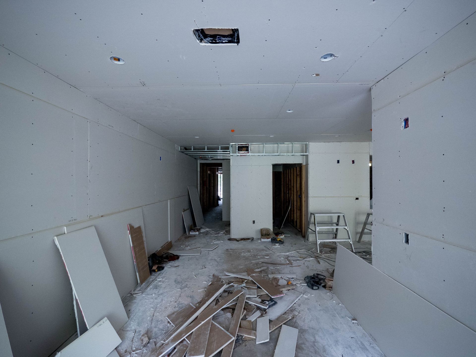 Room interior with drywall installation and construction work in progress